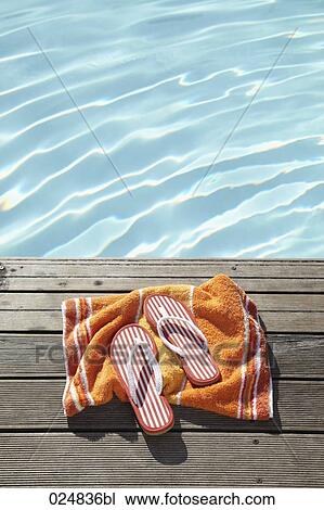 flip flops on towel at swimming pool View Large Photo Image Stock Image - flip flops on towel at swimming pool. Fotosearch