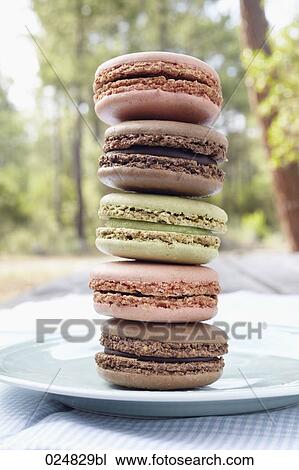 Stock Image - pile of five macarons on plate. Fotosearch