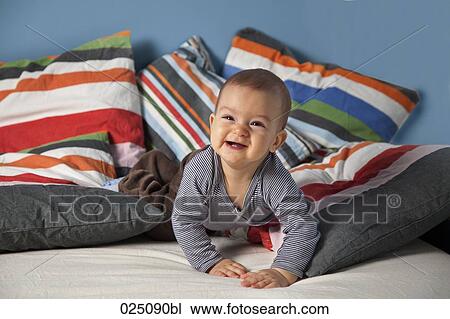 Stock Image - portrait of baby in bed. Fotosearch