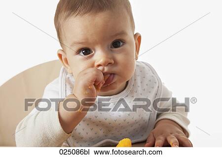 baby eating in high chair