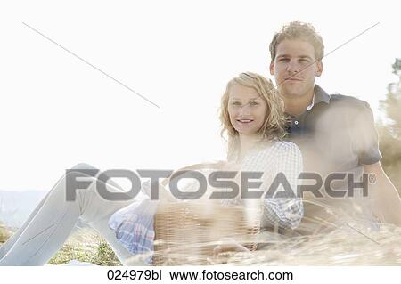 portrait of young couple having picnic in field View Large Photo Image Stock Image - portrait of young couple having picnic in field. Fotosearch
