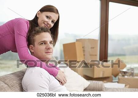 Stock Image - portrait of young couple in new flat. Fotosearch
