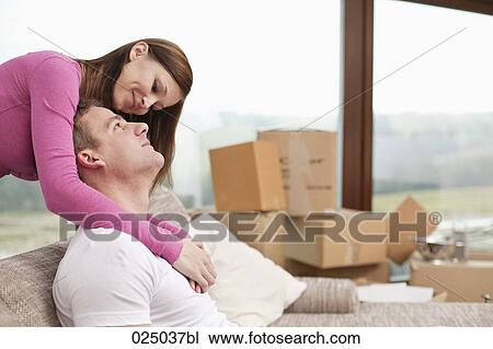 Stock Image - portrait of young couple in new flat. Fotosearch