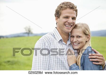 portrait of young couple on meadow View Large Photo Image Stock Image - portrait of young couple on meadow. Fotosearch