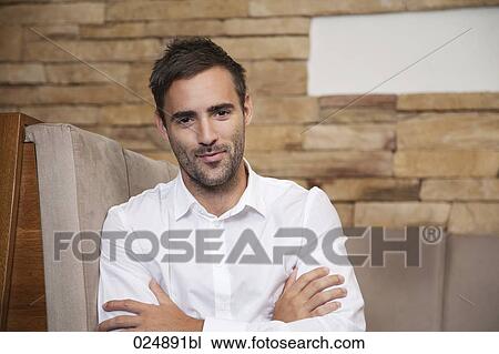 Stock Image - portrait of young man at restaurant. Fotosearch