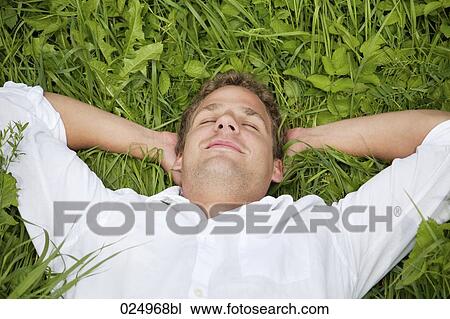 portrait of young man relaxing in grass View Large Photo Image Stock Image - portrait of young man relaxing in grass. Fotosearch