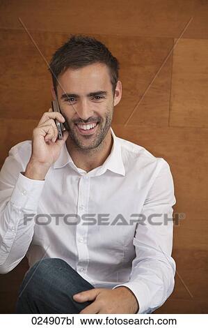 portrait of young man talking on mobile phone View Large Photo Image Stock Image - portrait of young man talking on mobile phone. Fotosearch