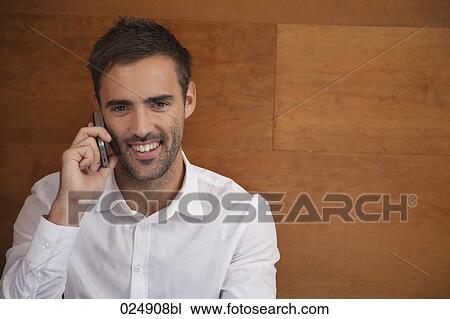 portrait of young man talking on mobile phone View Large Photo Image Stock Image - portrait of young man talking on mobile phone. Fotosearch