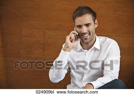 portrait of young man talking on mobile phone View Large Photo Image Stock Image - portrait of young man talking on mobile phone. Fotosearch