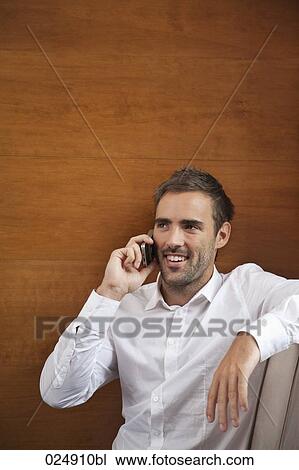portrait of young man talking on mobile phone View Large Photo Image Stock Image - portrait of young man talking on mobile phone. Fotosearch