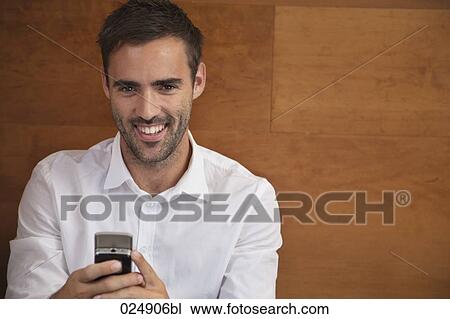 portrait of young man with mobile phone View Large Photo Image Stock Image - portrait of young man with mobile phone. Fotosearch
