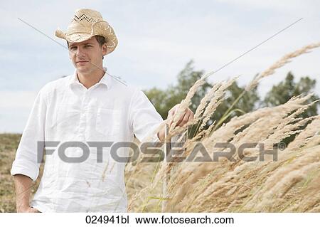 portrait of young man with straw hat in field View Large Photo Image Stock Image - portrait of young man with straw hat in field. Fotosearch