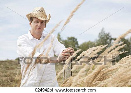 portrait of young man with straw hat in field View Large Photo Image Stock Image - portrait of young man with straw hat in field. Fotosearch