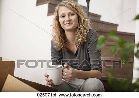 Stock Image - portrait of young woman at home. Fotosearch