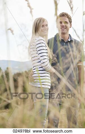 Stock Image - portrait of young woman behind reeds. Fotosearch