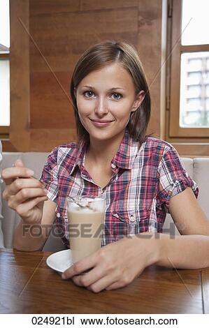 portrait of young woman having glass of latte View Large Photo Image Stock Image - portrait of young woman having glass of latte. Fotosearch