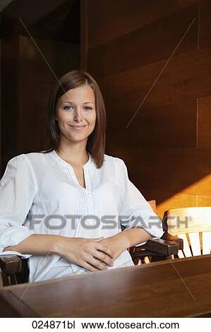 portrait of young woman sitting at restaurant table View Large Photo Image Stock Image - portrait of young woman sitting at restaurant table. Fotosearch