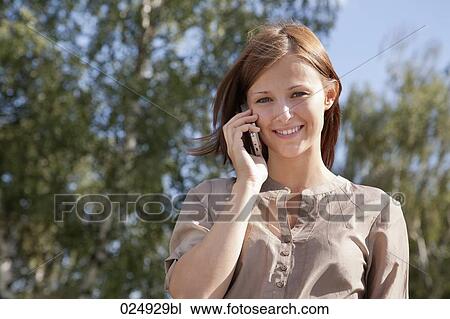 portrait of young woman talking on mobile phone View Large Photo Image Stock Image - portrait of young woman talking on mobile phone. Fotosearch