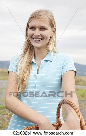 Stock Image - portrait of young woman with basket. Fotosearch