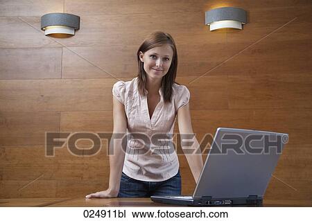Stock Image - portrait of young woman with laptop computer. Fotosearch
