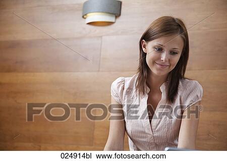 Stock Image - portrait of young woman with laptop computer. Fotosearch