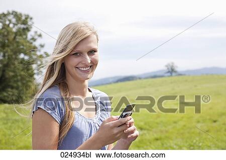 portrait of young woman with mobile phone View Large Photo Image Stock Image - portrait of young woman with mobile phone. Fotosearch