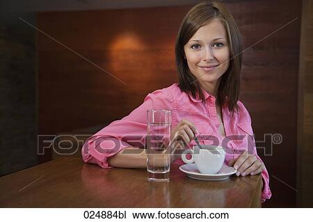 portraitof young woman having cup of coffee at cafe View Large Photo Image Stock Image - portraitof young woman having cup of coffee at cafe. Fotosearch
