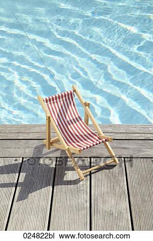 sun lounger on planks at swimming pool View Large Photo Image Stock Image - sun lounger on planks at swimming pool. Fotosearch