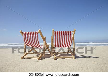 two sun loungers on sandy beach View Large Photo Image Stock Image - two sun loungers on sandy beach. Fotosearch
