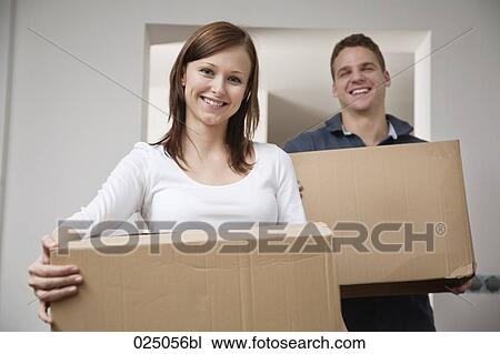 young couple carrying moving boxes View Large Photo Image Stock Image - young couple carrying moving boxes. Fotosearch
