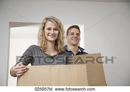 young couple carrying moving boxes View Large Photo Image Stock Image - young couple carrying moving boxes. Fotosearch