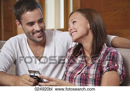 Stock Image - young couple flirting with each other. Fotosearch