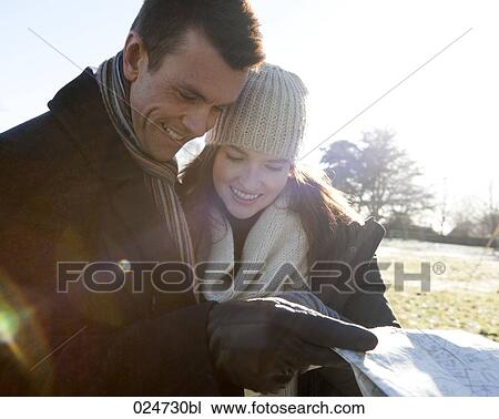 young couple having a walk in winter looking at map View Large Photo Image Stock Image - young couple having a walk in winter looking at map. Fotosearch