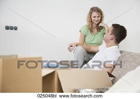 young couple having conversation in new home View Large Photo Image Stock Image - young couple having conversation in new home. Fotosearch