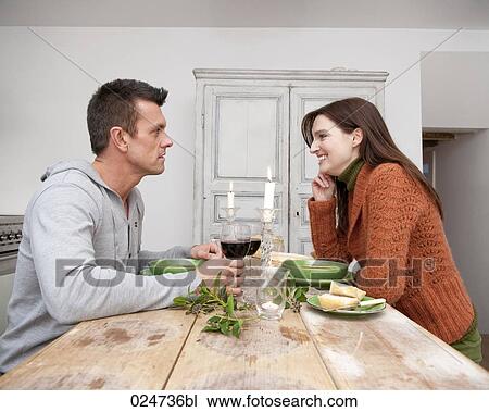 Stock Image - young couple having meal together. Fotosearch