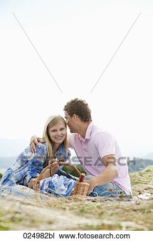 young couple having picnic in field View Large Photo Image Stock Image - young couple having picnic in field. Fotosearch