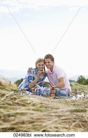 young couple having picnic in field View Large Photo Image Stock Image - young couple having picnic in field. Fotosearch