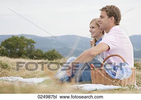 young couple having picnic in field View Large Photo Image Stock Image - young couple having picnic in field. Fotosearch