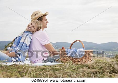 young couple having picnic in field View Large Photo Image Stock Image - young couple having picnic in field. Fotosearch
