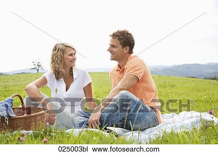 Stock Image - young couple having picnic. Fotosearch