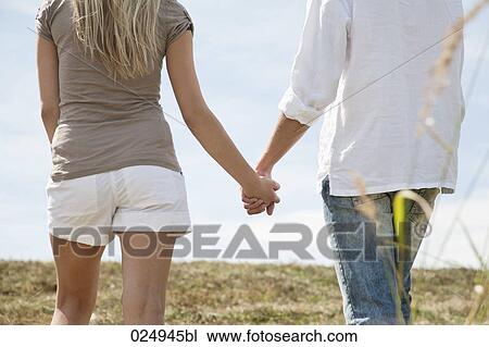 young couple holding hands in field View Large Photo Image Stock Image - young couple holding hands in field. Fotosearch