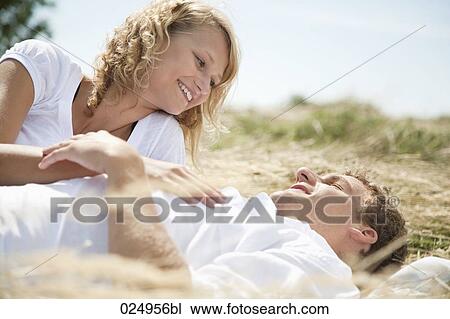 young couple lying in field in summer View Large Photo Image Stock Image - young couple lying in field in summer. Fotosearch