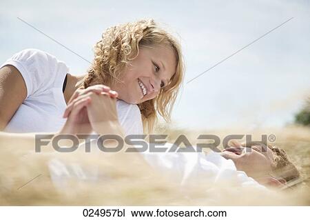 young couple lying in field in summer View Large Photo Image Stock Image - young couple lying in field in summer. Fotosearch