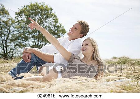 young couple lying in field in summer View Large Photo Image Stock Image - young couple lying in field in summer. Fotosearch