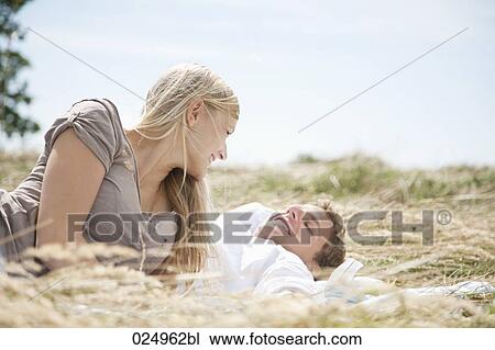 young couple lying in field in summer View Large Photo Image Stock Image - young couple lying in field in summer. Fotosearch