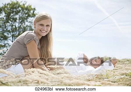 young couple lying in field in summer View Large Photo Image Stock Image - young couple lying in field in summer. Fotosearch