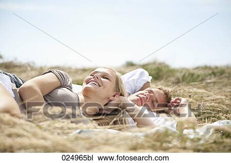 young couple lying in field in summer View Large Photo Image Stock Image - young couple lying in field in summer. Fotosearch