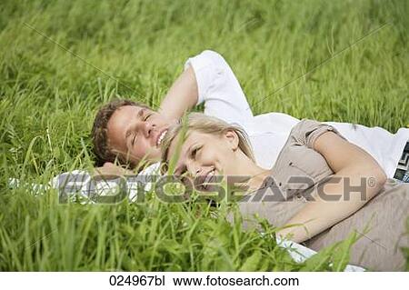 young couple lying in grass View Large Photo Image Stock Image - young couple lying in grass. Fotosearch
