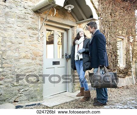 young couple opening door too weekend house in winter View Large Photo Image Stock Image - young couple opening door too weekend house in winter. Fotosearch
