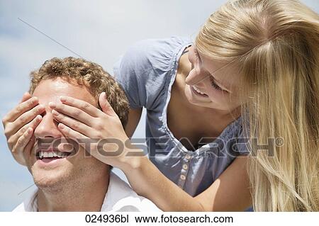 young couple playing peekaboo View Large Photo Image Stock Image - young couple playing peekaboo. Fotosearch